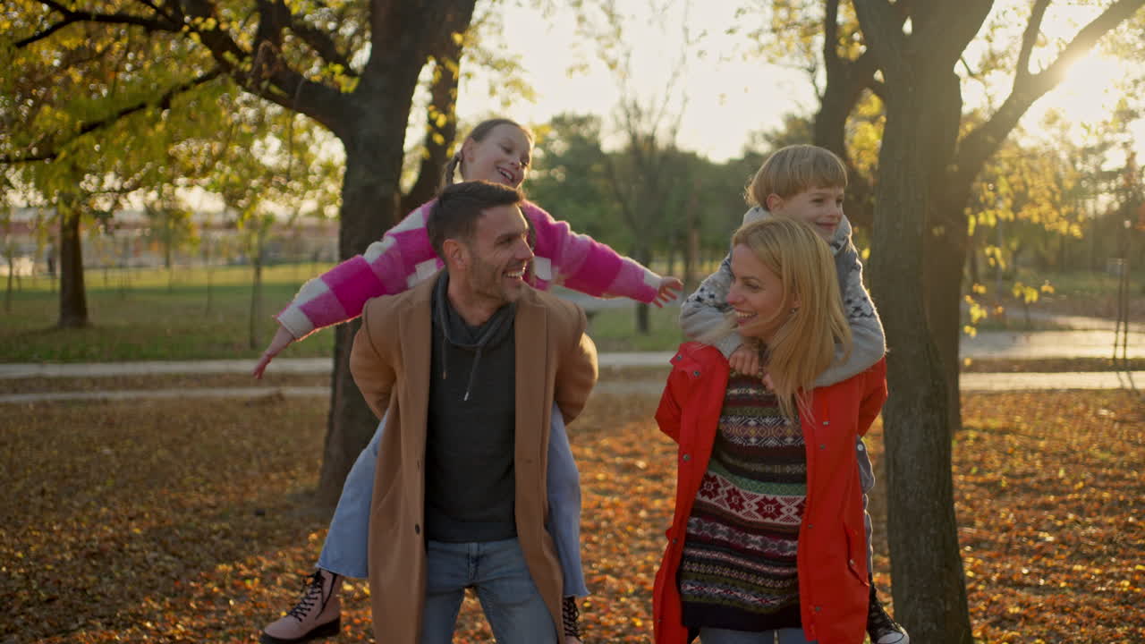 Happy Family Enjoying Autumn in the Park