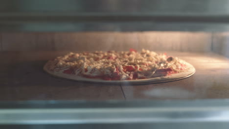 putting pizza into oven. italian pizza in oven