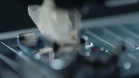 sewing needle in slow motion. manufacturing equipment at textile factory