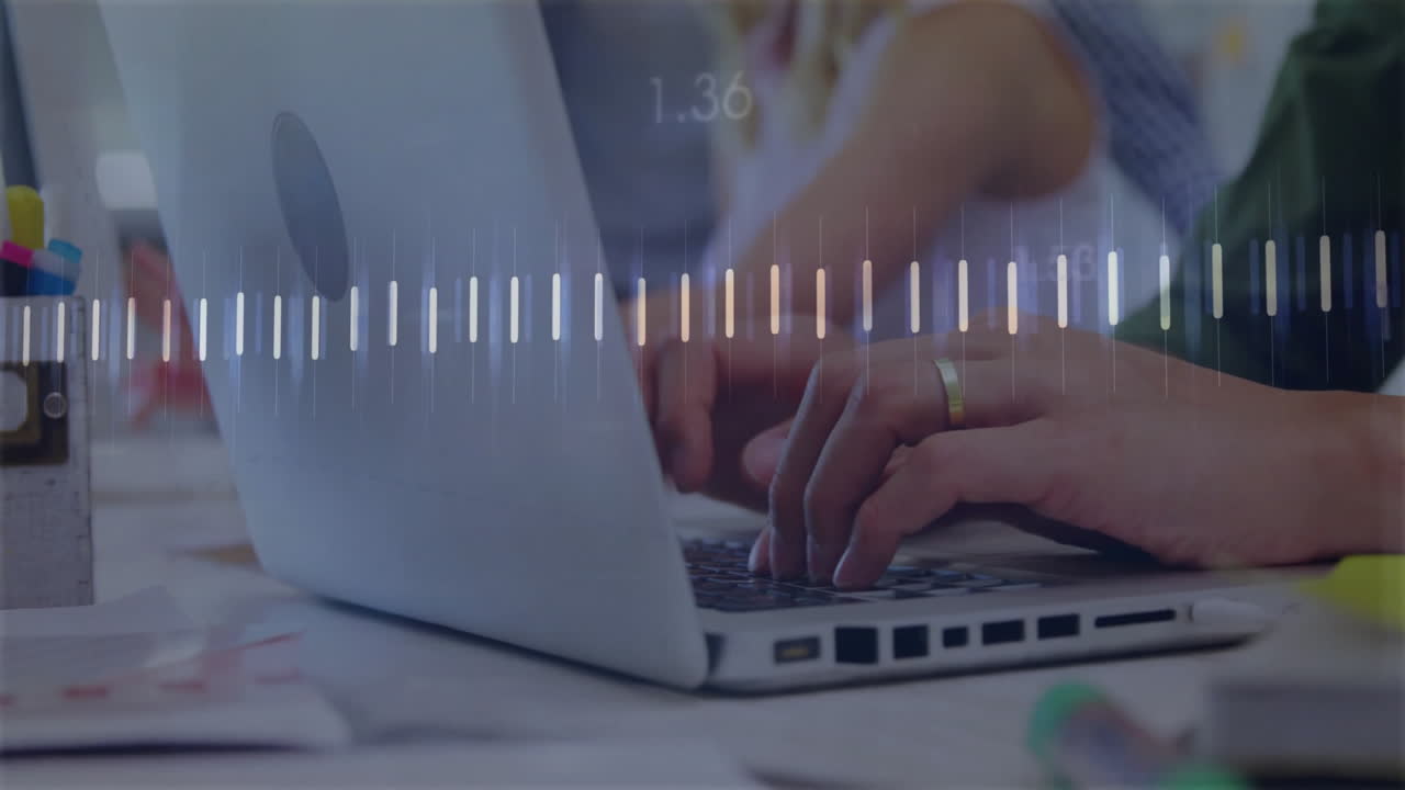 Man typing on laptop at business office desk, showing animated charts floating above keyboard