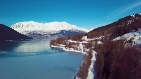 4K-Drone-Video-of-Snow-Covered-Lakeside-Mountains-in-Alaska-During-Winter