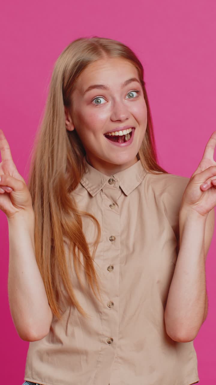 Woman lady showing victory v sign hoping for success and win doing peace gesture with two fingers