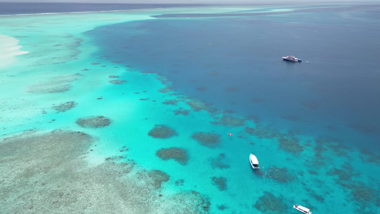 Maldives Indian Ocean paradise with boat carrying tourist for snorkelling and diving exploring the coral reef