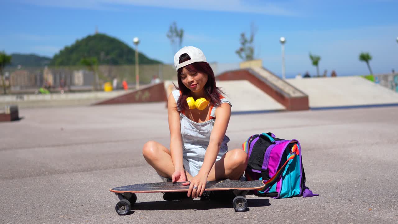 Young Woman with Skateboard and Backpack