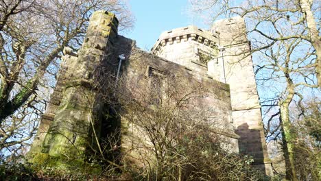 abandoned autumn woodland old watchtower stone castle keep building in rural english countryside