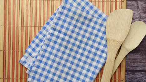 wooden cutlery fork and spoon on a chopping board on table ,