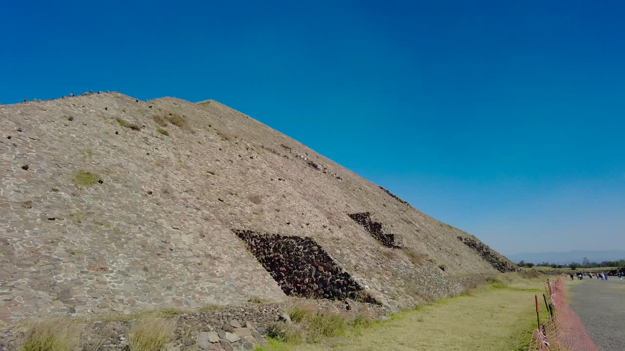 Majestic aztec pyramid covered with a blue sky, Teotihuacan, Mexico. Video from the ground