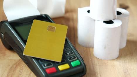 contactless payment concept with credit card and pos machine on table