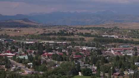 small town nestled in a valley with mountains in the distance on a sunny day