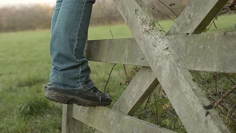 muddy boots on countryside gate