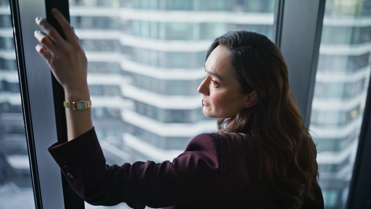 Thoughtful woman contemplating cityscape closeup. Serious pensive boss thinking