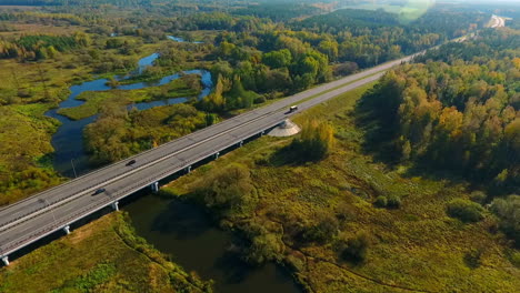 Sky-view-cars-driving-along-bridge.-Car-moving-on-bridge-over-river