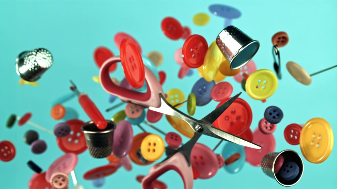 Colorful Sewing Buttons and Craft Supplies Floating on Blue Background