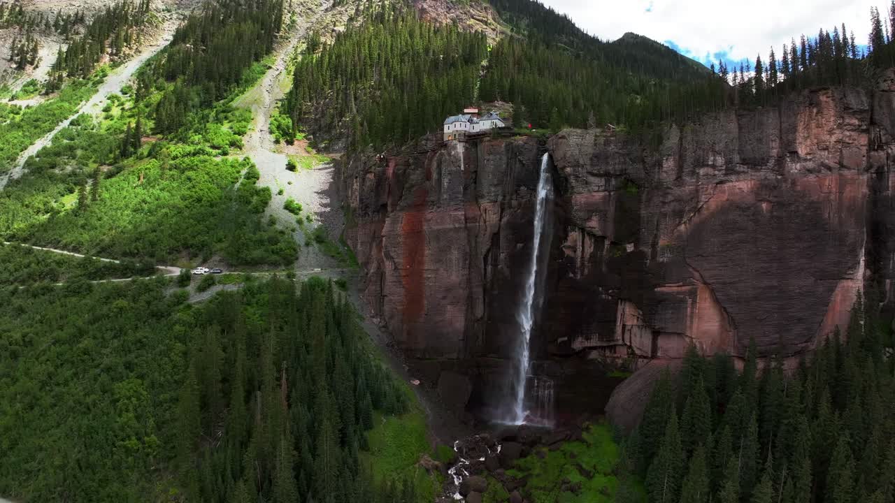 Summer green Telluride Bridal Veil Falls Waterfall Colorado powerplant house aerial drone upward jib down Box Canyon Black Bear Pass Road Rocky Mountains 4wd hiking blue sky cliffs Uncompahgre Forest