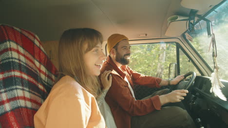 happy couple enjoying road trip in van