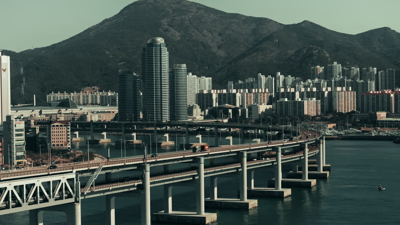 Cityscape of a Korean coastal city with a curved bridge over a bay