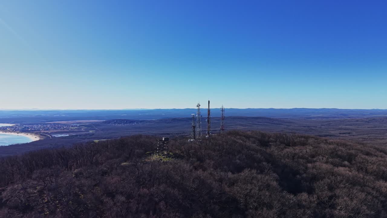View of communication towers on a mountain during bright day