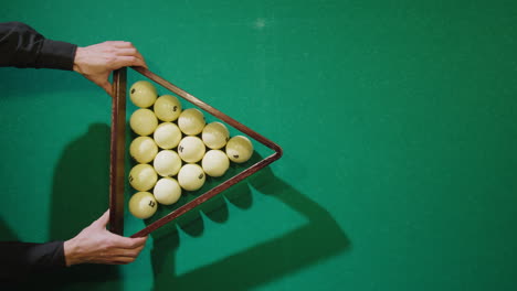 breaking white pool balls top view on green billiards table for start to play. russian biliard game, russian pyramid. billiard balls with numbers on a pool table. billiards team sport. high quality 4k footage