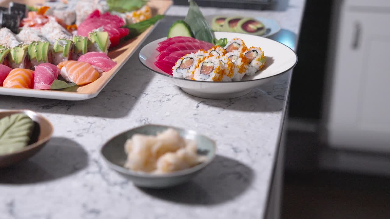 A roaming shot of a table filled with decorative assorted sushi rolls, showcasing a variety of sushi types. Perfect for highlighting sushi presentation, food displays, and restaurant menus.