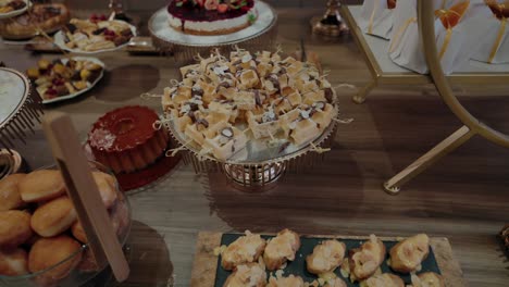 dessert table with a variety of cakes, pastries, and sweets arranged elegantly