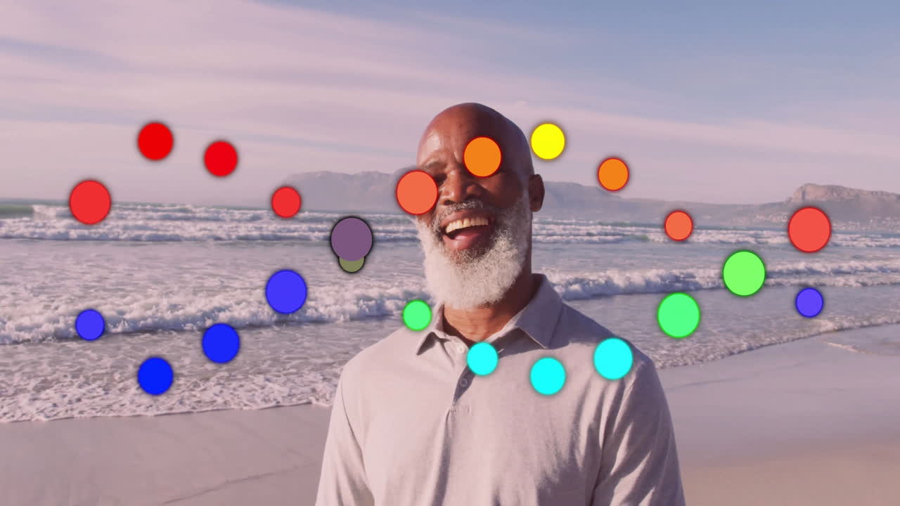At beach, man smiling with colorful circles animation overlay in background
