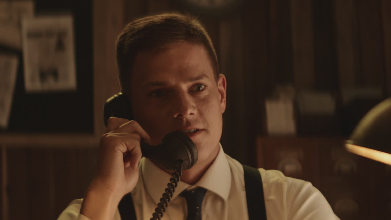Man Talking on Vintage Telephone in a Retro Office