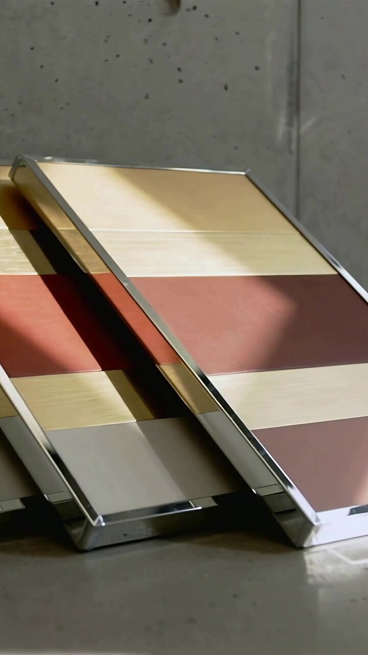 Vertical video: Shifting view showing three chrome striped panels on tabletop, revealing bands