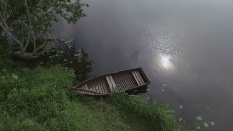 Un-Bote-De-Madera-Vacío-En-Un-Río-Sinuoso-En-Un-Día-Nublado-De-Verano-1