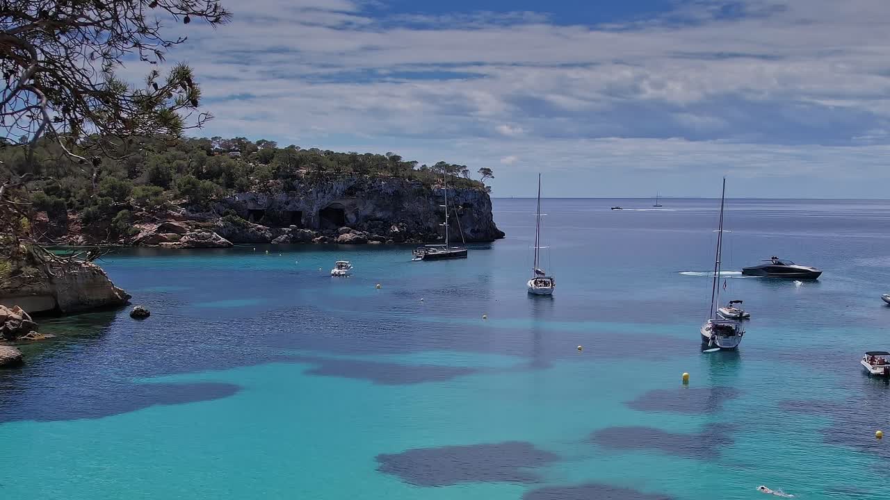 View of boats on clear water in Mallorca, Spain from above