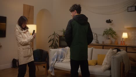 couple looking at a phone in a living room