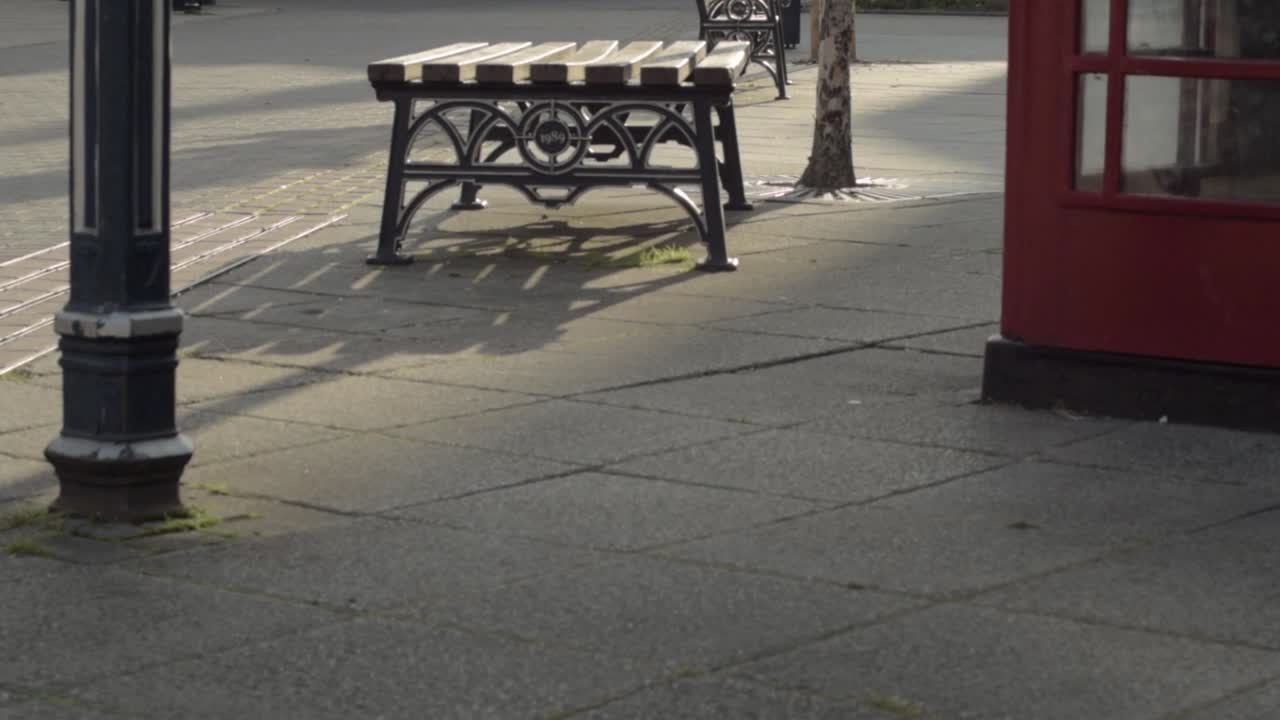 British town center scene with benches and red phone box