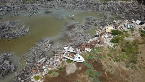 Boat-Wreck-and-Trash-on-Lagoon-Coast-of-Puerto-Rico,-Aftermath-of-Hurricane-Disaster,-Aerial-View