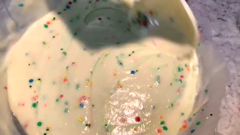 Hand-stirring-Funfetti-cake-batter-in-a-large-mixing-bowl