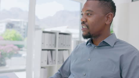 Black-man-drinking-coffee-at-office-desk