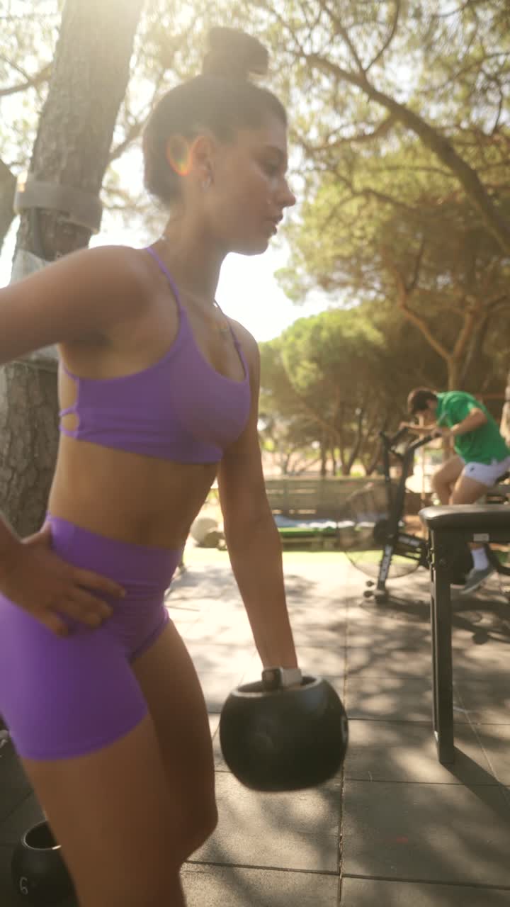 People exercising outdoors in a sunlit park gym