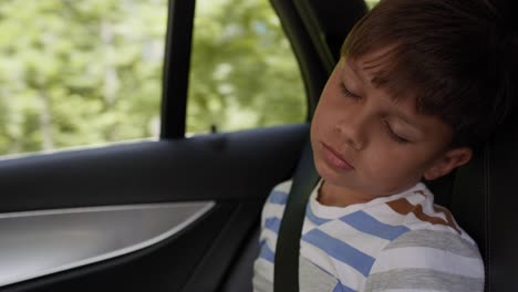 video of boy sleeping while riding in car