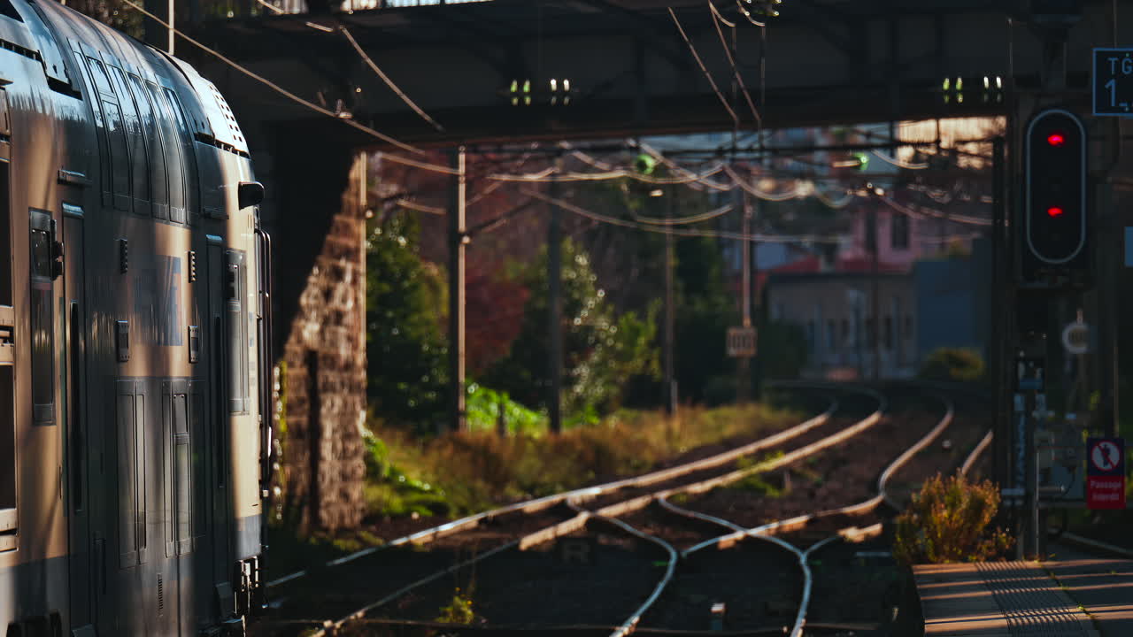 Close up of a train moving on the rails near a station in the south of France at sunset