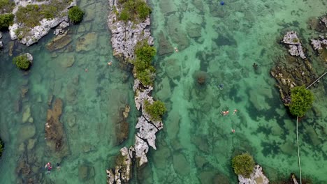 Drone-shot-of-clear-water-lagoon-in-the-south-of-Mexico-at-Yal-Ku,-Akumal