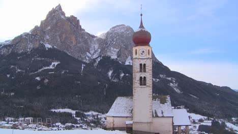 time lapse clouds over an eastern church in a snowbound tyrolean village in the alps in austria switzerland italy slovenia or an eastern european country 1