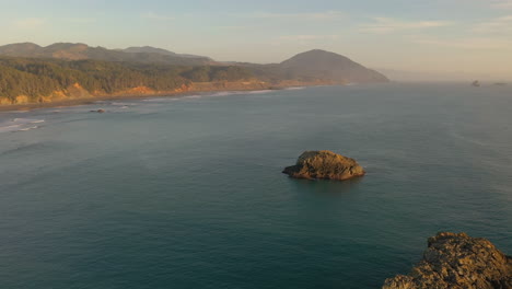 Aerial-pullback-shot-over-Oregon-coast-sea-stacks-during-golden-hour