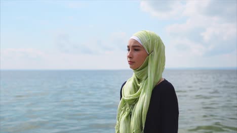 woman in hijab by the sea