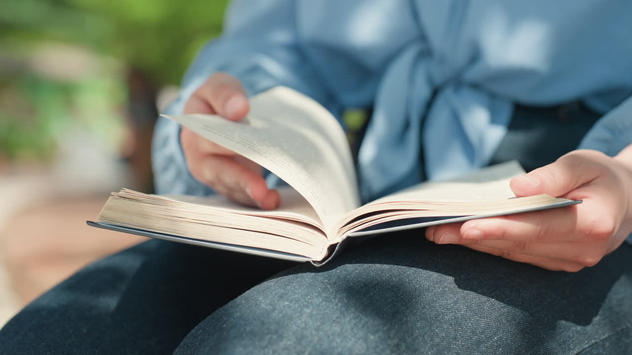 젊은 백인 독자가 무릎에 책을 올려놓고 훑어보고 있고, 연구원은 주의 깊은 손길로 여백에 필기를 하고 있으며, 은은한 공원 조명과 캐주얼한 데님 복장, 의도적인 리듬으로 책장이 바스락거리는 소리, 사려 깊은 모습