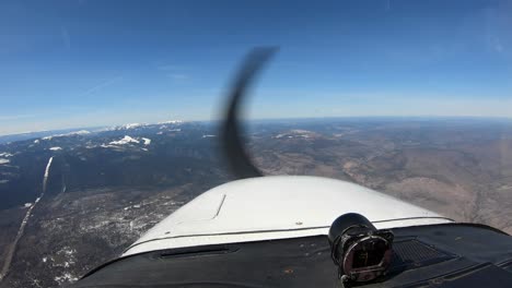 perspective view from cockpit of a private aircraft flying over canadian landscape at daytime