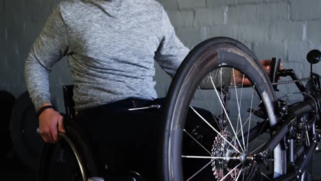 Disabled-man-repairing-wheelchair-at-workshop-4k