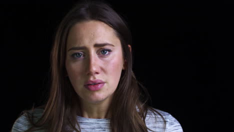 Close-Up-Of-Unhappy-Young-Woman-Looking-Sadly-Into-Camera