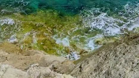 cala ratjada waves against stone cliffs of the coast on the island of palma de mallorca