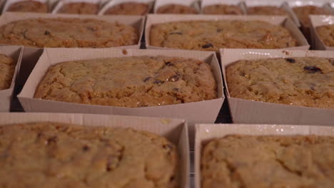 golden cakes in cardboard ready to be packaged and labelled