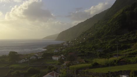 rural-coastal-village-and-crop-fields-in-lush-green-cliffs,-Fajã-dos-Vimes,-São-Jorge-island,-the-Azores,-Portugal