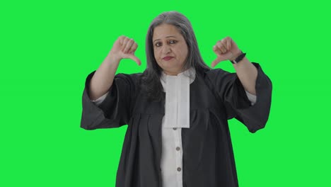 Disappointed-Indian-senior-female-lawyer-showing-thumbs-down-Green-screen