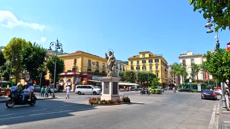 traffic and pedestrians in a lively square